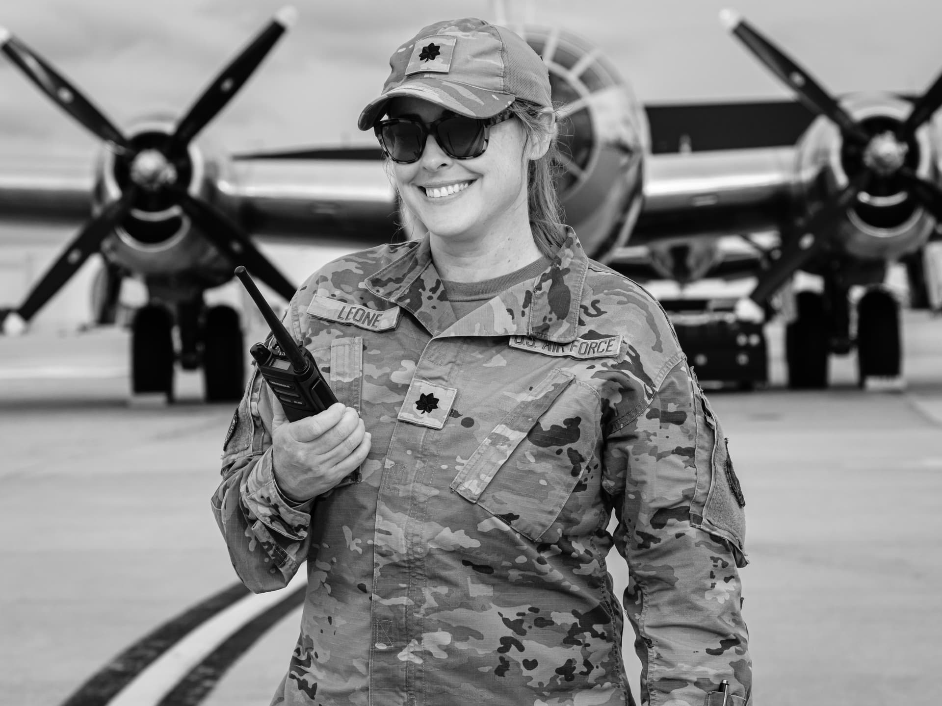 Smiling soldier poses near a plane