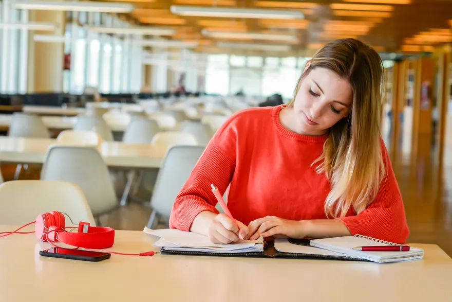 A young student studying at a university library